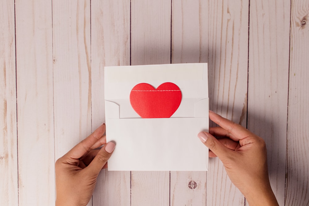 A handwritten kindness card being opened